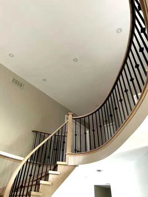 Smooth finished ceiling above a curved staircase from EPFβs project gallery