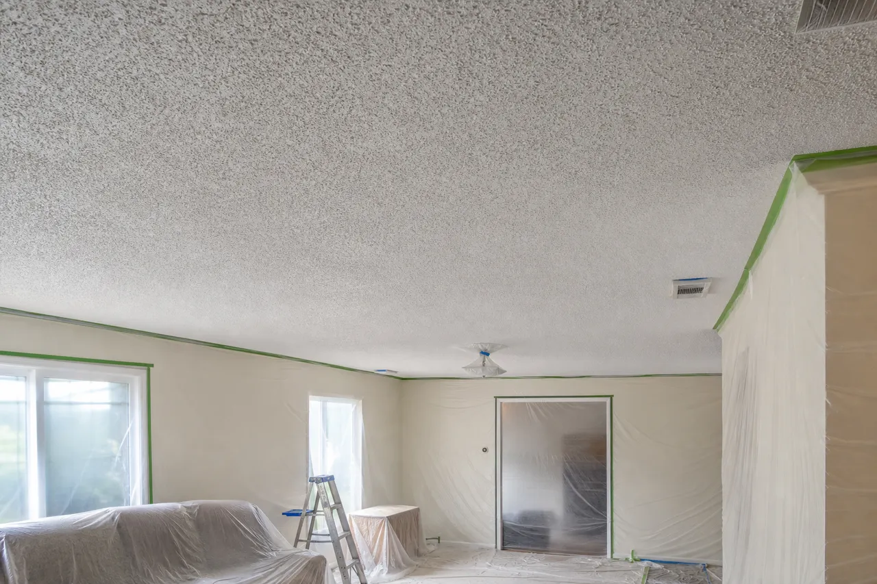 Protected room with painted popcorn ceiling before removal