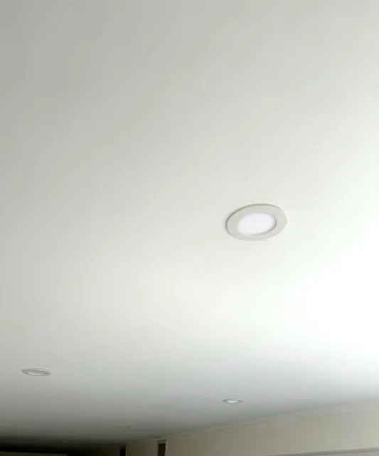 Smooth white ceiling finished around recessed lights